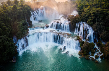Majestic Ban Gioc waterfall, Detian Falls flowing in tropical forest during the sunset at Cao Bang, Vietnam