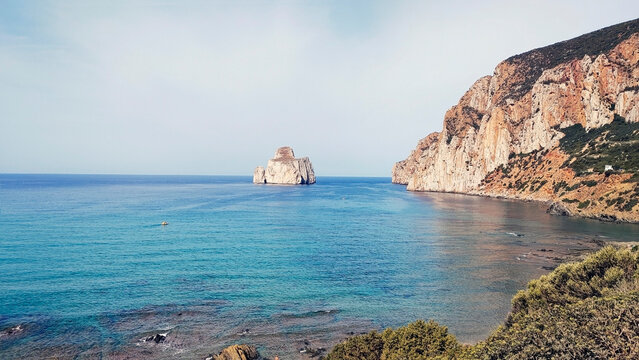 Masua, a former old mining hamlet in Iglesias, Sardinia, Italy. ‘Pan di Zucchero’ is an ancient sea stack along the coast of Masau near the old Porto Flavia a UNESCO-protected site. - Powered by Adobe