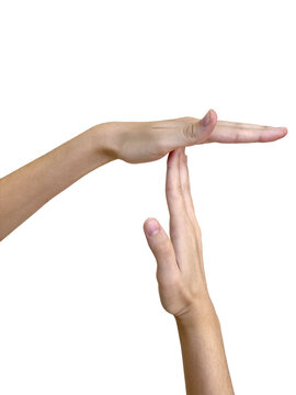 Caucasian adult making hand gesture for time out signal with arms crossed.