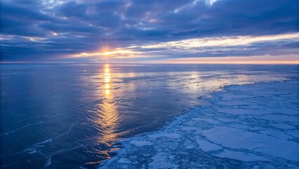 A serene Arctic landscape with ice floes and mountains at sunset, showcasing polar beauty.
