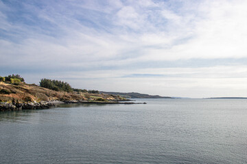 Perfect seascape with rocky beach on left side and calm water on right side in Ireland
