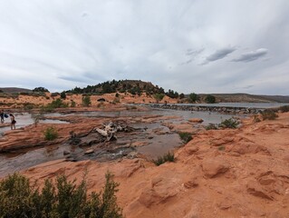 Scenic View of Gunlock Falls with Flowing Water and Red Rock Landscape in Utah.