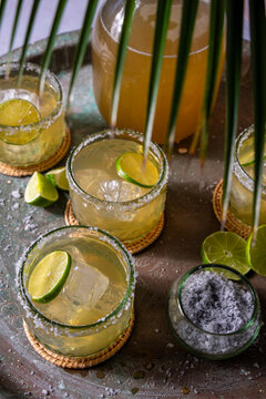 Margaritas and a pitcher with lime slices 