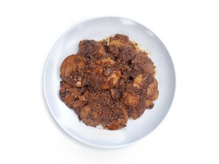 Semur jengkol or dogfruit with soy sauce and spices on plate isolated on white background, Flat lay Indonesian food