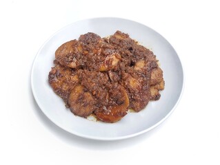 Semur jengkol or dogfruit with soy sauce and spices on plate isolated on white background, Indonesian food 