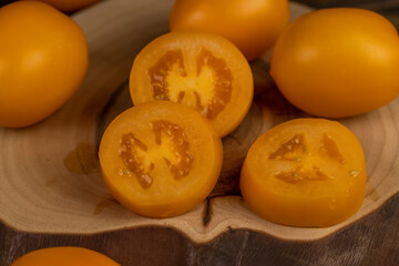 whole clean washed tomatoes are sliced for cooking