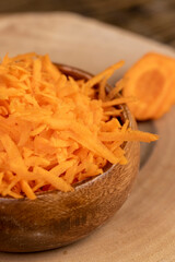 grated orange carrots on the table during cooking