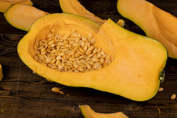 freshly cut orange pumpkin with cooking seeds