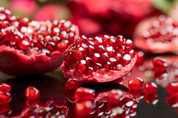 large ripe pomegranate seeds on the table