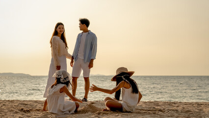 Happy family beach vacations.Group of multi generation family little girl with parents and grandparents relax and enjoy together on the beach.