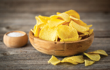 Delicious salty potato chips in the bowl