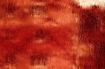 red wet glass with water droplets