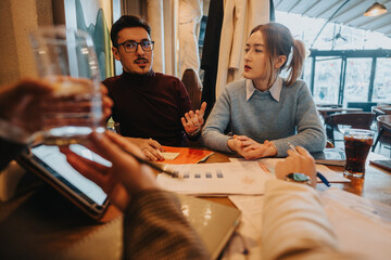 Group of professionals engaged in collaborative discussion, brainstorming and sharing ideas during...