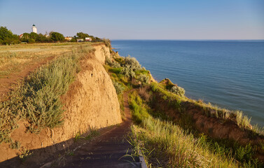 Coastal Cliffs with a View of the Sea and a Lighthouse