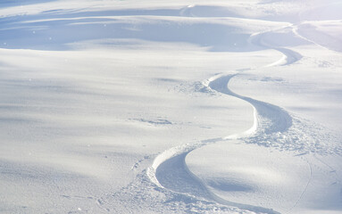 Snowboard tracks in the snow. Winter landscape.