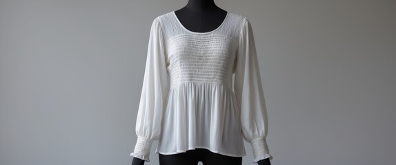 A long sleeve ribbed top sweater displayed on a headless mannequin set against a backdrop.