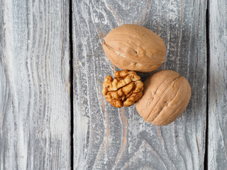 Walnut with shell on wooden background.