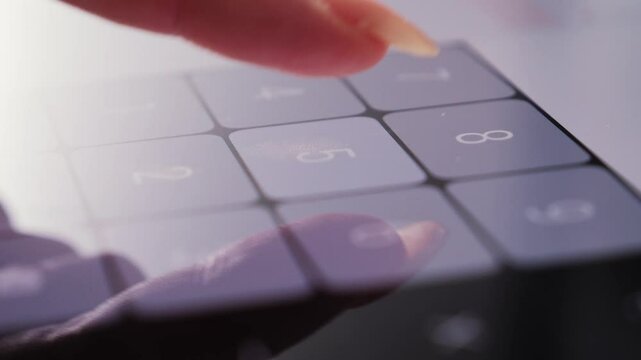 Footage of a person doing basic math on a smartphone calculator. High quality 4k footage