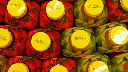 Bright juice packaging on store shelf showcasing vibrant fruit juice bottles Juice variety vivid design and colorful caps highlight shelf impact and mass juice production in supermarket setting