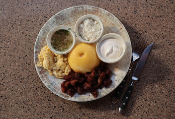 traditional Moldavian dish mamaliga - corn porridge and greaves with cutlery