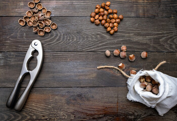 Hazelnuts in a canvas bag on a wooden table.