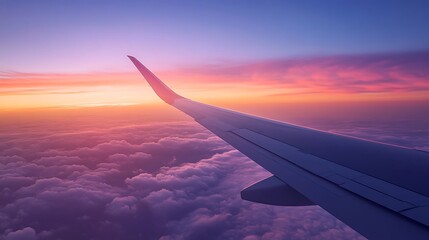 Fototapeta premium Sunset Flight: A breathtaking view of cloudscape from an airplane wing during a vibrant sunset.