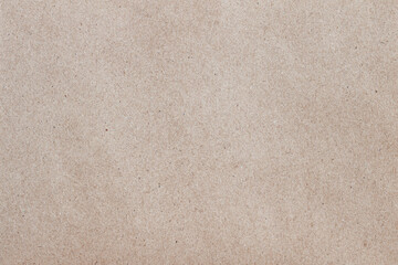 Close-up of natural paper texture in soft beige tone with visible fibers and organic pattern. Concept of eco background, craft surface and design material