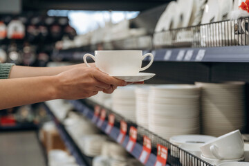 New cups. Close up view of woman that is in the hardware store