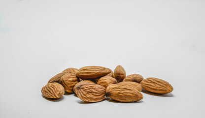 A Pile Of Almonds On A White Background With Copy Space