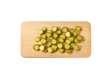chopped pickled cucumbers on a cutting board  isolated on a white background, top view.