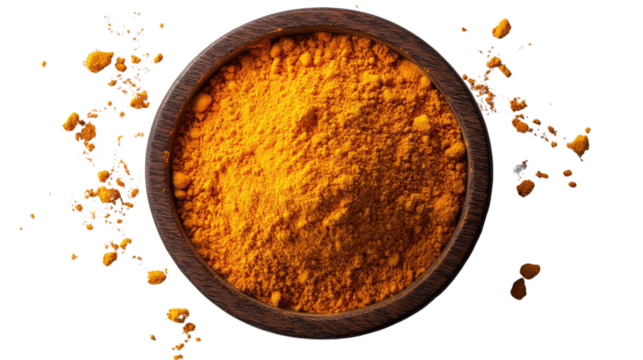 Spice of Life: A top-down view presents a dark wooden bowl brimming with bright turmeric powder. Splashes of the vivid spice around the bowl add an element of motion and texture.