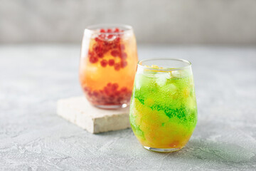 Glasses of homemade fruit lemonade with popping boba or bubble pearls. Trendy summer drink