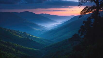 Obraz premium View of the valley above the verdant hills of the National Park at dusk.