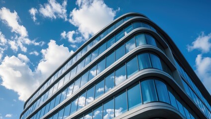 Fototapeta premium Architecture details of a modern building featuring glass facades and reflections in curved windows.