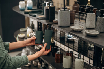 Soap container for bathroom. Close up view of woman that is in the hardware store