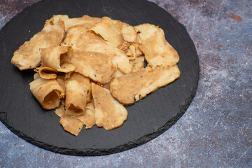 Seitan: vegan meat alternative made with vital wheat gluten, sliced on slate board