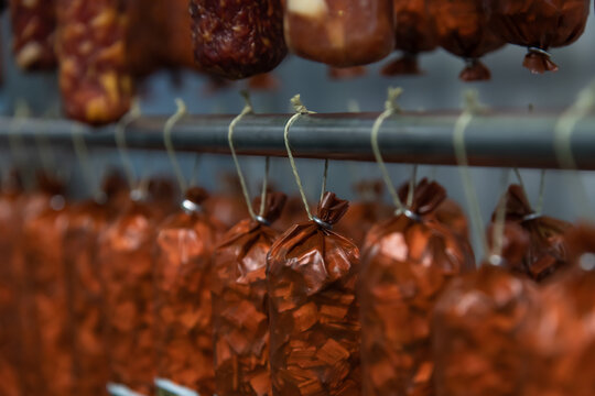 Hanging sausages drying in a rustic food processing facility