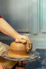 Close-up of male potter's hands making a vase. Pottery. Making ceramics.