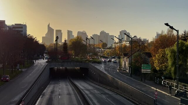 Empty Road with City Skyscrapers of La D&eacute;fense in Background and Golden Morning Light

