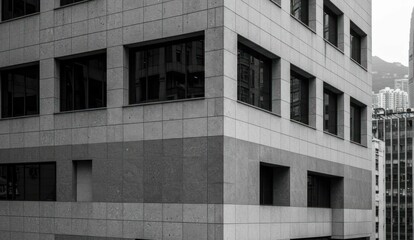 Modern building facade with geometric pattern in gray, clean and simple.