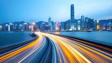 Obraz premium Colorful light trails Speed curving along a waterfront highway, leading towards a vibrant, illuminated against cityscape a dramatic twilight sky