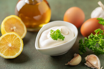 Garlic  Aioli sauce in bowl and ingredients  on the table.