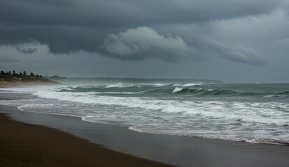 Gloomy beach view with crashing waves, dark sand, and stormy skies.