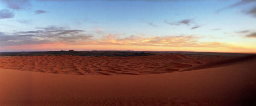 Panoramic view of the Sahara Desert landscape at sunset, Morocco.