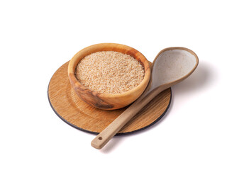 Psyllium husk in the plate with spoon on white background.