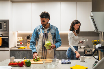 Couple preparing healthy meal together in modern kitchen