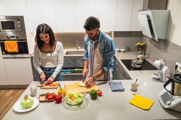 Young couple preparing healthy meal together in modern kitchen