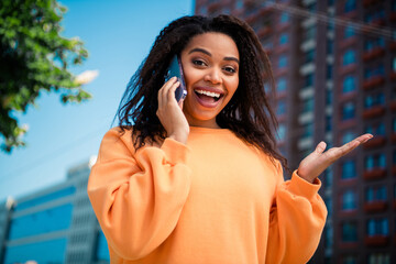 Photo of excited good mood woman dressed orange pullover walking communicating modern gadget...