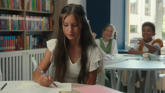Sad worried Caucasian frustrated girl teen upset schoolgirl pupil student suffer bullying in school classroom victim child kid studying alone problem cruel children classmates laugh abuse bully mock