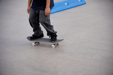 Skateboarder riding on skateboard in skatepark
